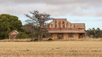 Abandoned old brick farmhouse with a red rusty roof and shed - Yorke Peninsula, South Australia