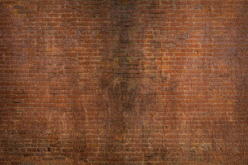 Scary background of an old rusty red brick grunge wall texture, the concept of horror, and Halloween