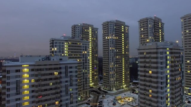Residential complex against cityscape at winter evening. Aerial view