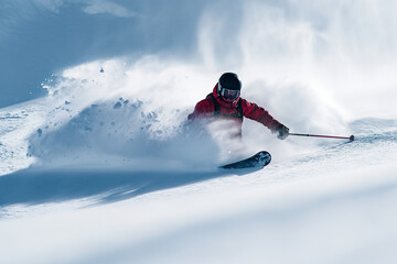Fototapeta na wymiar Skier in Red Jacket Descending Hill