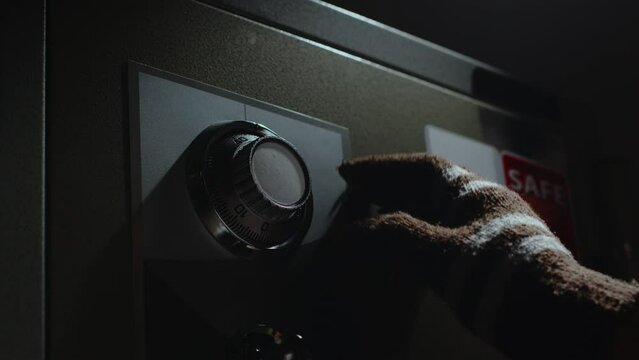 Steal wearing a glove put on a password on dial to open safe box