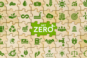 The concept of net zero and carbon neutrality Green net zero icon on wooden jigsaw puzzle For the...