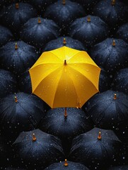 A single colorful yellow umbrella in the middle of a lot of black umbrellas. 