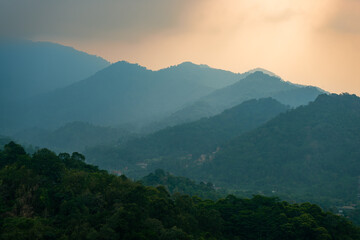 layers of mountains covered with fog during rainy season at mount sanggabuana, karawang