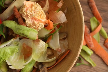 Peels of fresh vegetables on table, top view