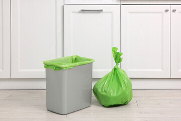 Plastic garbage bag and trash can in kitchen