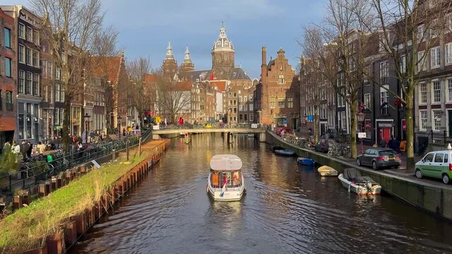 Traditional old narrow houses boats and canals in Amsterdam, Netherlands, Europe, January 20, 2024. High quality 4k footage
