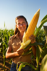 Corn's bounty is clear as a farmer presents a ripe cob, surrounded by a healthy corn field, epitomizing sustainable agriculture with corn