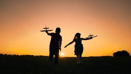silhouette happy boy girl child play airplane pilot sunset, children family dream flying, our...
