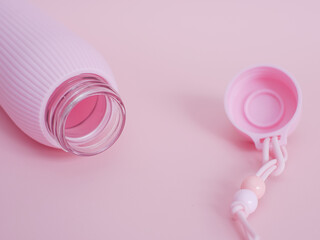 Pink plastic bottle on pink background. Minimal concept.