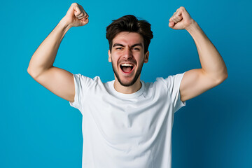 Fototapeta premium Photo of ecstatic young man shout loud yeah fist up raise win lottery isolated blue background
