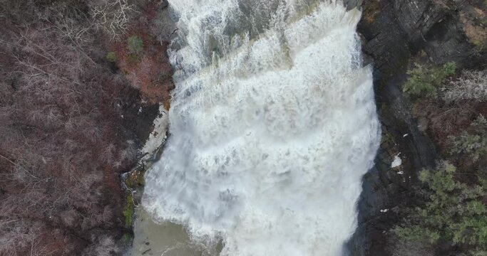 Afternoon winter aerial video of flowing Ithaca Falls on Fall Creek, City of Ithaca, NY, USA 01-27-2024	