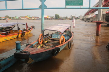 A wooden ship for transporting goods waiting for its cargo