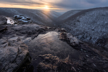 Delicate ice crystals forming in small puddle during a winter sunset from Lindy Point at the Blackwater Canyon in West Virginia.