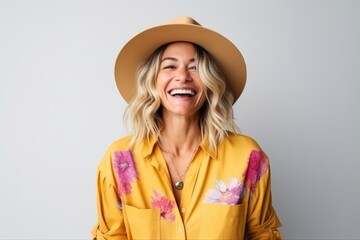 Portrait of a beautiful young woman laughing and wearing a straw hat