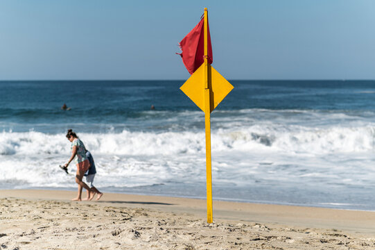Red warning flag on tropical beach of  Zicatela, Oaxaca, Mexico