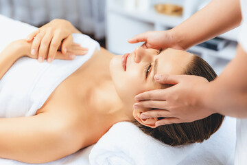 Caucasian woman enjoying relaxing anti-stress head massage and pampering facial beauty skin...