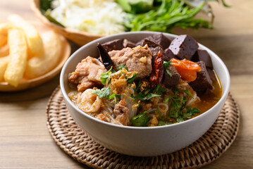 Northern Thai food (Kanom Jeen Nam Ngeaw), Spicy rice noodles soup with pork and pork blood eating with fresh vegetables