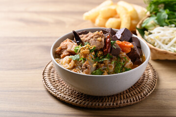 Northern Thai food (Kanom Jeen Nam Ngeaw), Spicy rice noodles soup with pork and pork blood eating with fresh vegetables