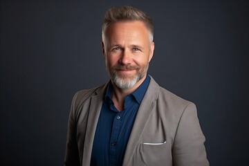 Portrait of a handsome mature man with grey hair and beard.