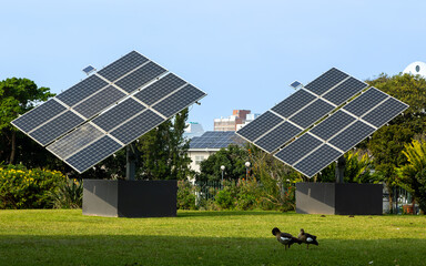 Two solar panels angled as if they are an artistic display in the Botanic gardens in Durban, South Africa. - obrazy, fototapety, plakaty