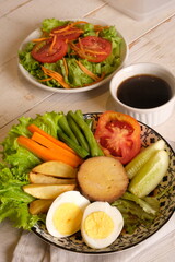 Selat Solo is a typical dish of Solo, Central Java, made from processed beef, fresh vegetables, eggs, french fries, boiled carrots. served with meat broth and mayonnaise sauce. Indonesian food. 