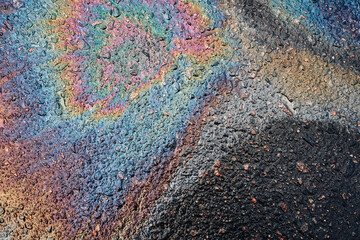 Beautiful abstract stain of motor oil, gas or petrol spilled on the asphalt