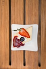 slice of cheesecake on plate with studio light ready to eat