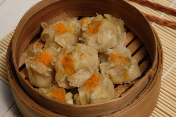 Delicious dim sum on bamboo steams. dim sum or dumpling is a snack from China and Hong Kong. Dim...