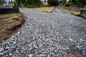 Begging of new residential construction, gravel road built with large rocks to handle heavy machinery
