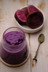 Ipomoea batatas. purple sweet potato smoothie in clear glass. a healthy diet containing lots of antioxidants and a source of carbohydrates.