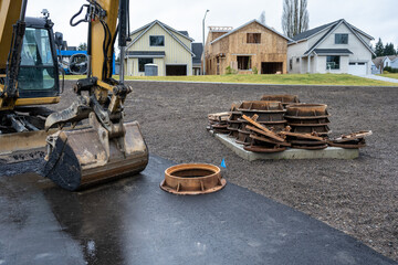 New residential community under construction, pile of sewer drain covered ready to be installed,...