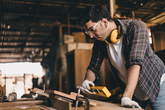 professional carpenter man hand working make wooden handcraft furniture master workpiece fine detail artisan with wood workshop.