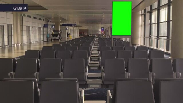 Green Screen Panel with empty seats in an International Airport