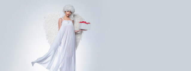 Naklejka premium Valentine sensual angel girl. Valentines Day symbol. Angel woman with wings isolated. Art photo of a Angelic beautiful woman.