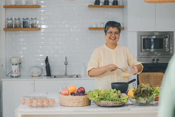 Senior Asian People elder happy living in home kitchen. Elderly  cooking in a kitchen. Happy mature man and woman in the kitchen, Active seniors. Older people relationship and activity