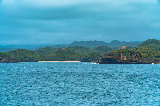 The blue sea and coral in the middle of the sea and the horizon line that separates the sea from the sky. The vast ocean at the tip of Java Island, Indonesia