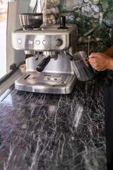 Barista warming milk working in a food truck