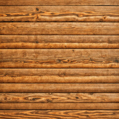 close-up of a wooden surface, with planks of wood. The grain of the wood is visible, and there are some visible knots