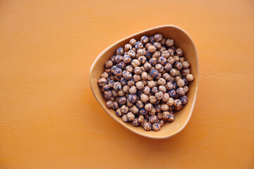 Roasted yellow chickpeas in a bowl .
