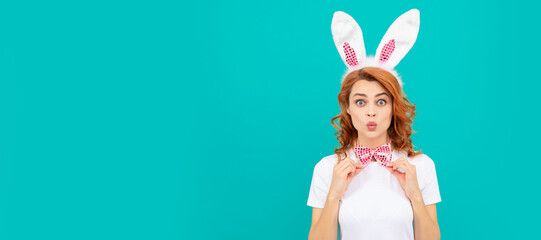Easter bunny woman. amazed happy easter girl in bunny ears and bow tie on blue background. Woman isolated face portrait, banner with mock up copyspace.