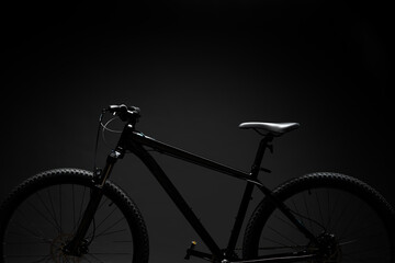 Black mountain bicycle on black background