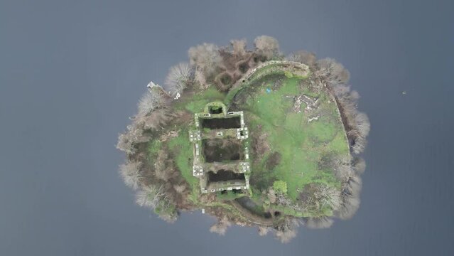 Aerial view of McDermott Castle ruins on an island in Lough Key, Roscommon, Ireland, with surrounding water