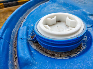 200 Liter HDPE Drum Cap Seal. Blue HDPE drum with white cap. high-angle view, Close-up. 