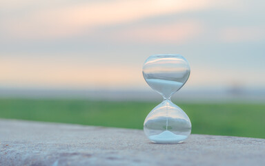 transparent hourglass on sand at BlueSky