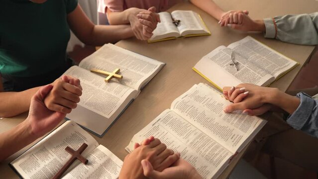 Sense of devotion and spiritual fulfill with christian catholic follower immerse in faith. Slow motion christian people practicing group prayer, holding hand while praying together. Burgeoning
