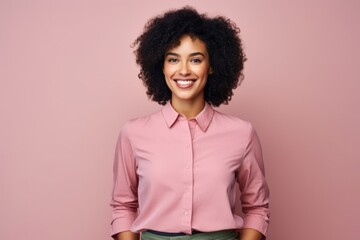 Obraz na płótnie Canvas Portrait of smiling african american businesswoman over pink background