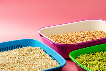 Pet litter box with bio filler on pink background