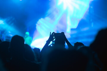 Abstract photo of crowd at concert and blurred stage lights.