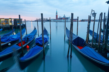 Early morning view of romantic Venice in blue twilight, with gondolas on the Grand Canal and San...